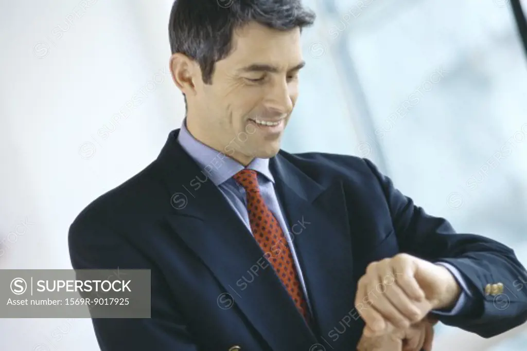 Businessman, looking at wrist