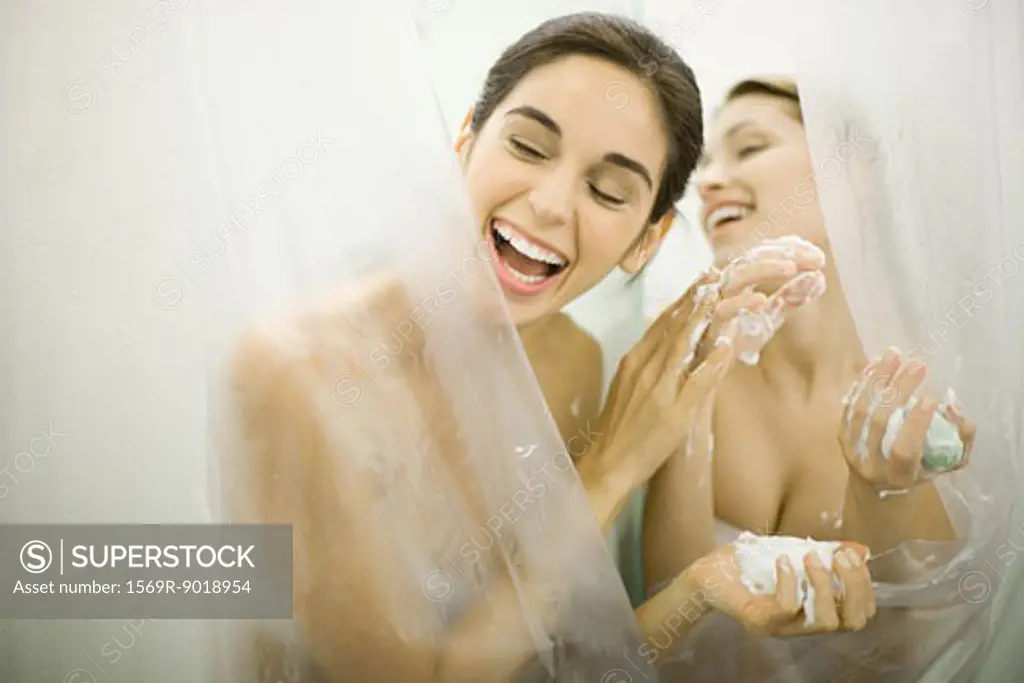 Woman handing friend soap in public showers