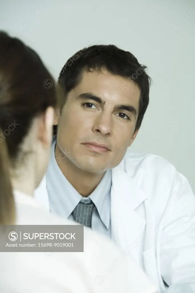 Doctor sitting across from female patient