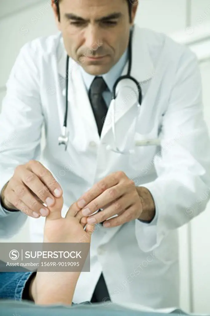 Doctor touching child's toes