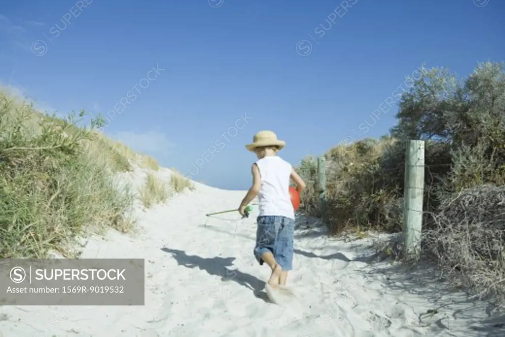 Child walking through dunes