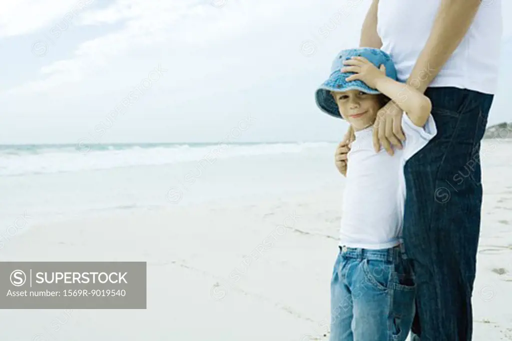 Child and parent on beach