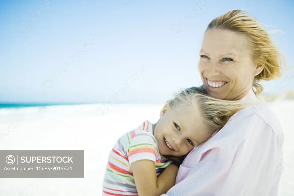 Little girl with mother on beach