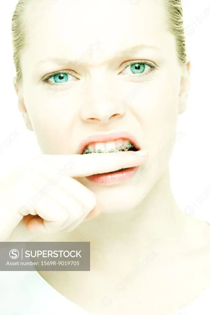 Teenage girl biting finger, close-up