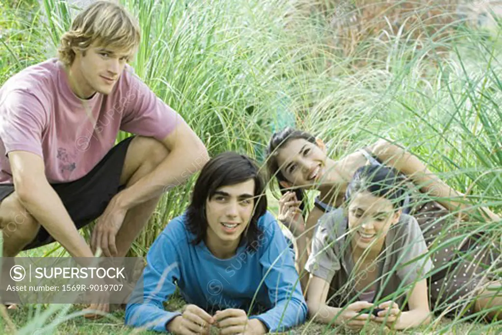 Young friends reclining in grass