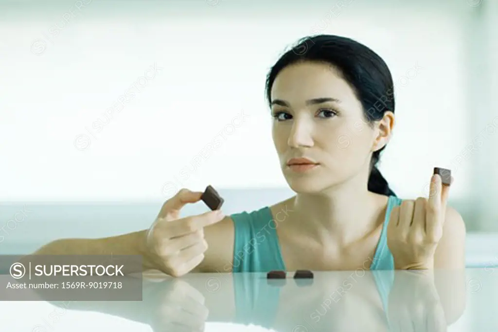 Woman holding up pieces of chocolate