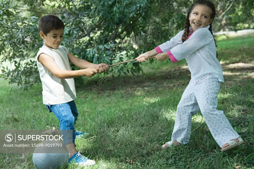 Girl and boy playing tug-of-war