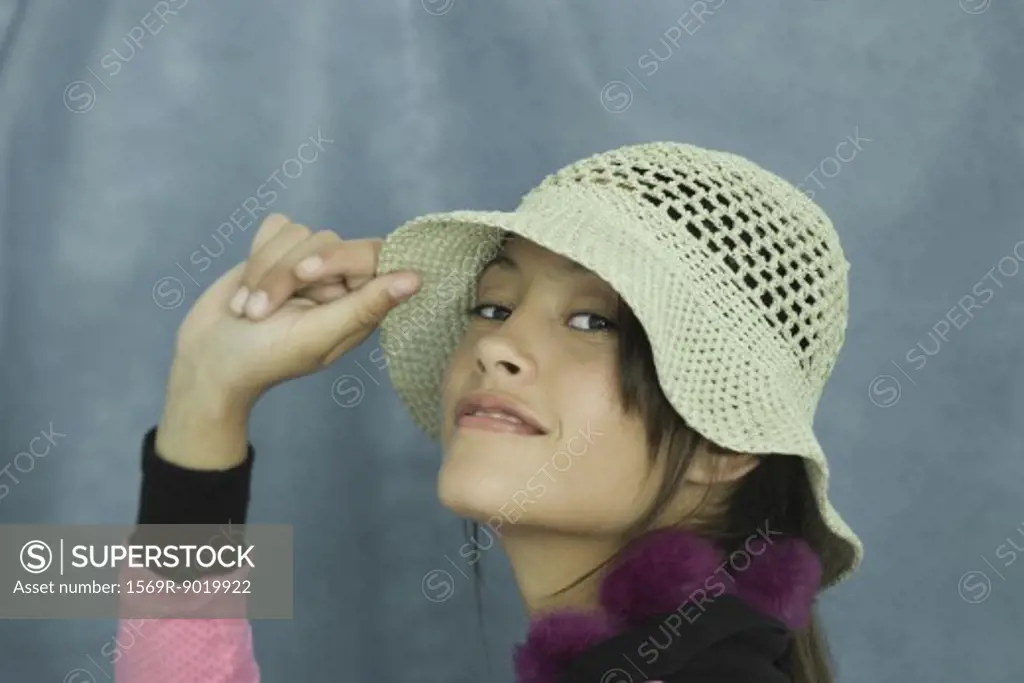 Teen girl wearing sun hat, close-up, portrait