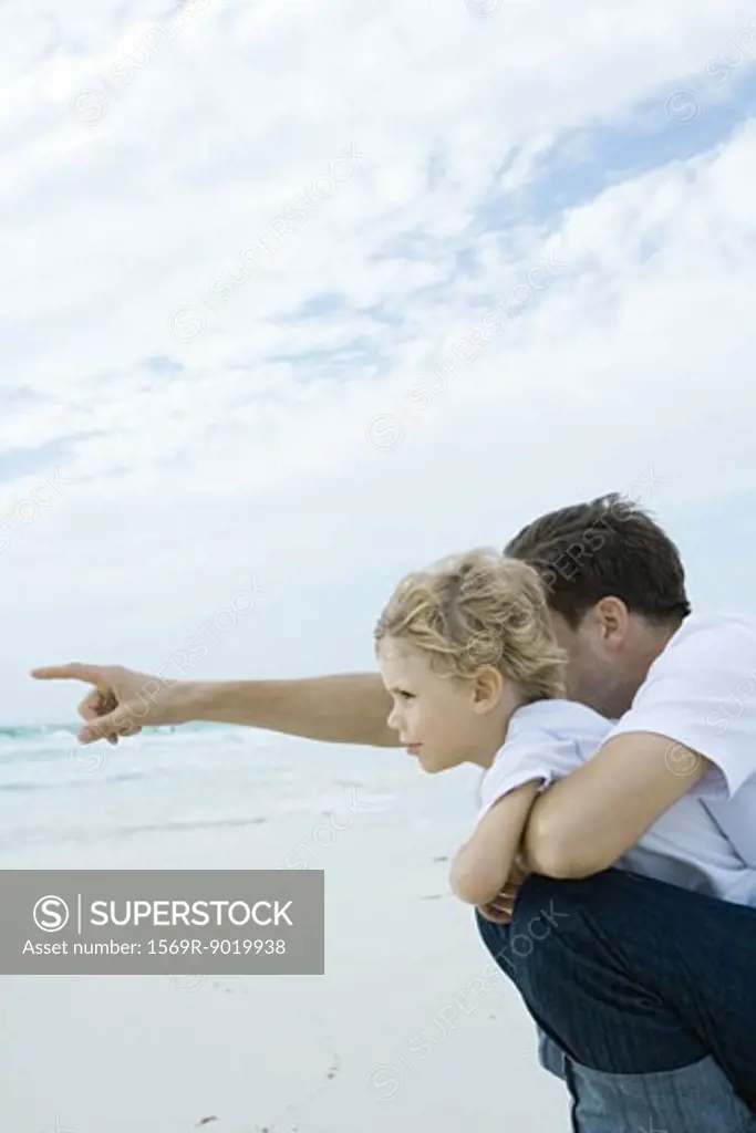 Boy and father on beach