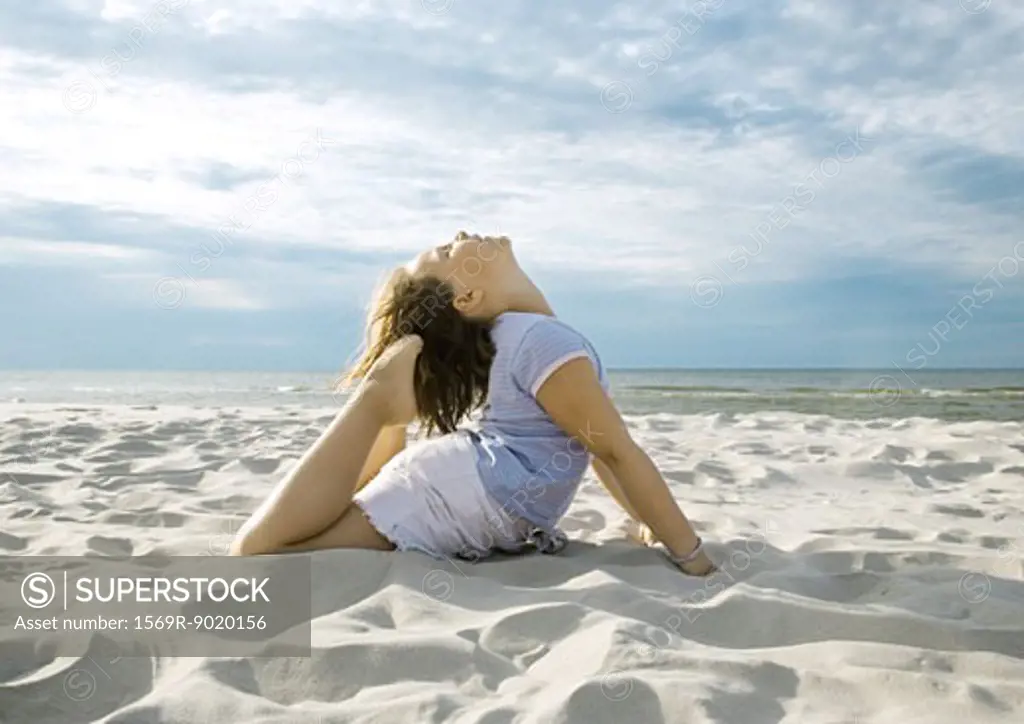 Girl doing yoga pose on beach