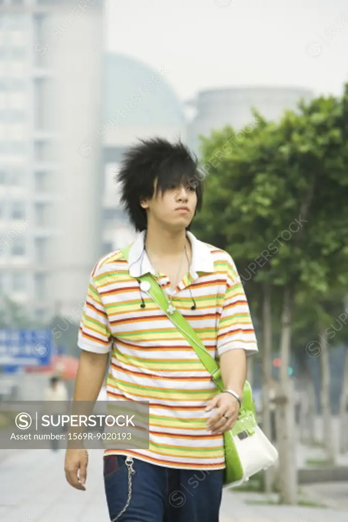Teenage boy walking in urban setting