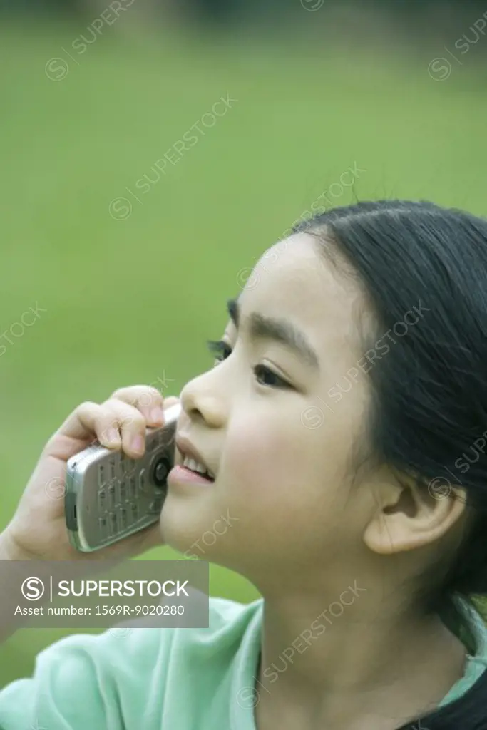 Girl using cell phone, close-up