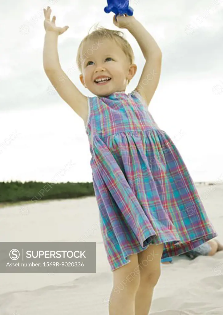 Little girl standing on beach