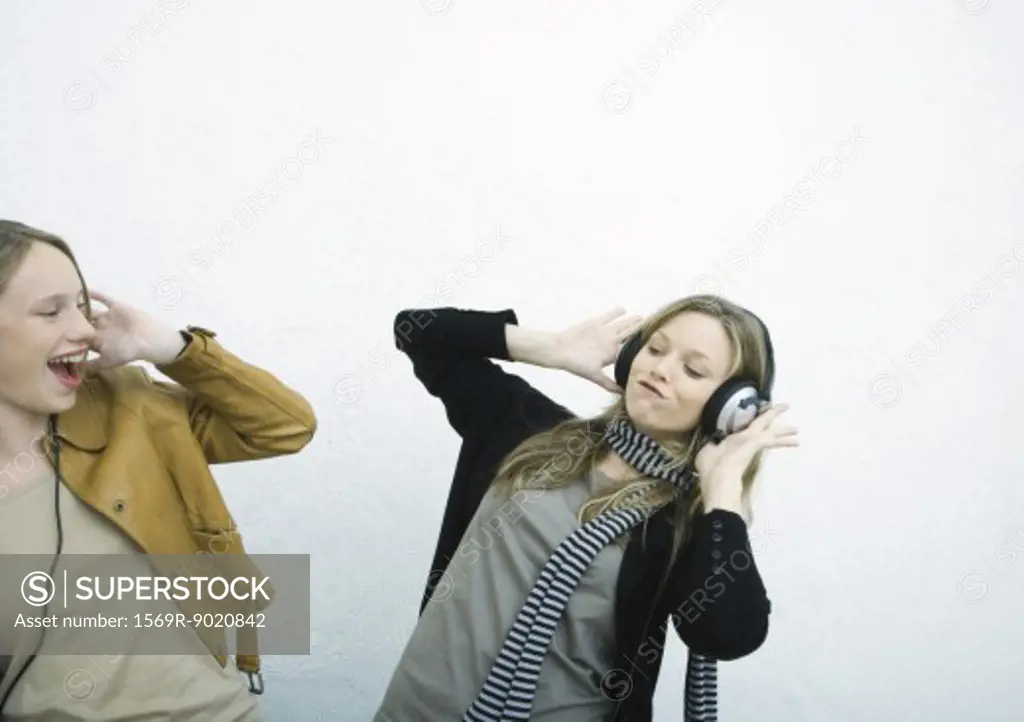 Teenage girls listening to headphones
