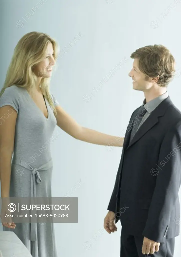 Young female professional standing face to face with mature businessman