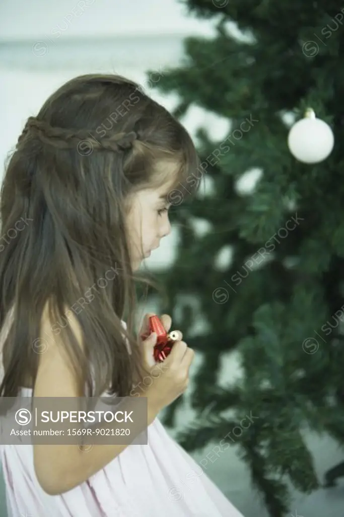 Girl looking at Christmas tree