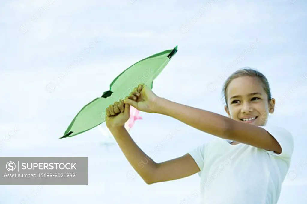 Girl holding up kite