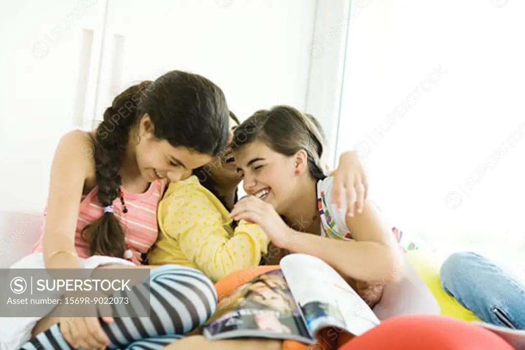 Three young female friends laughing