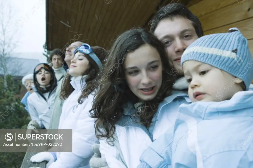 Group of skiers standing next to chalet