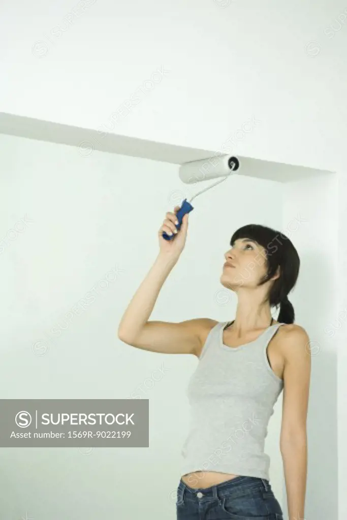 Woman painting with paint roller