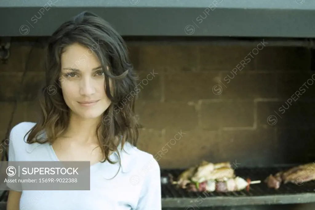 Woman standing in front of barbecue