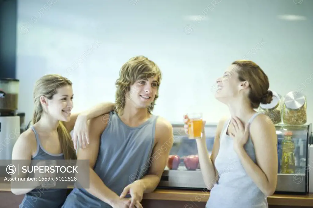 Young adults in exercise clothing taking break in health club cafeteria