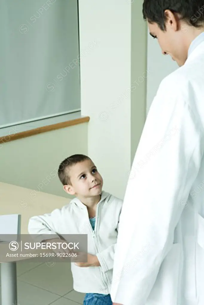 Boy looking up at doctor in doctor's office