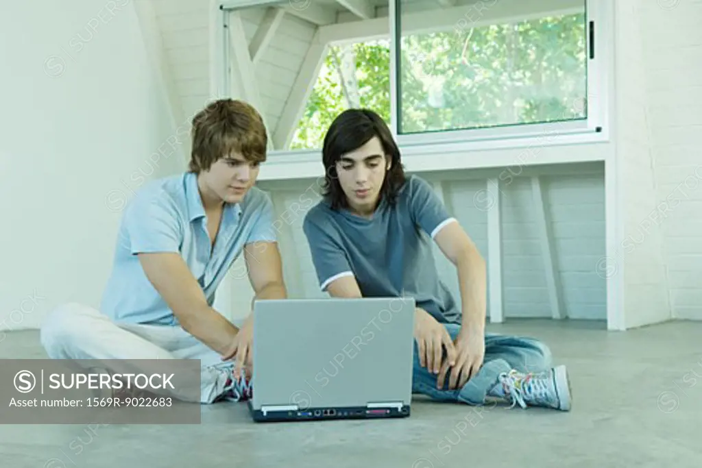 Teenage friends using laptop