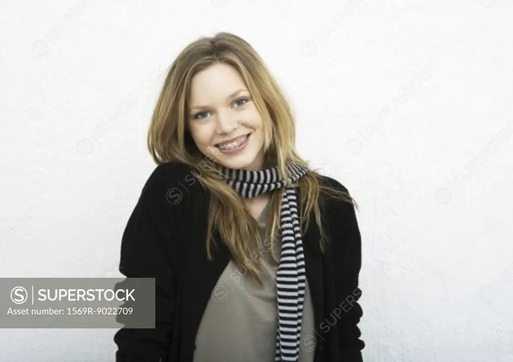 Teenage girl wearing scarf, smiling at camera