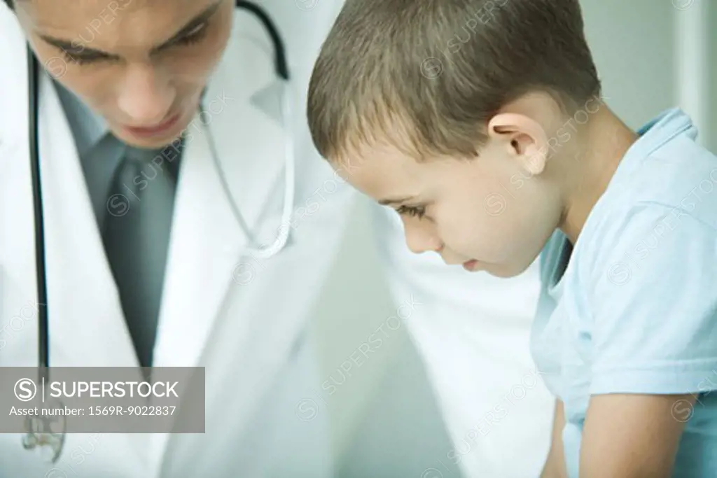 Doctor speaking to little boy