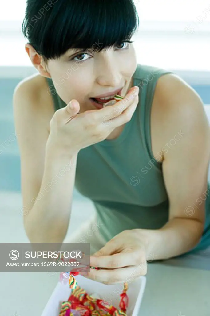 Young woman eating candy