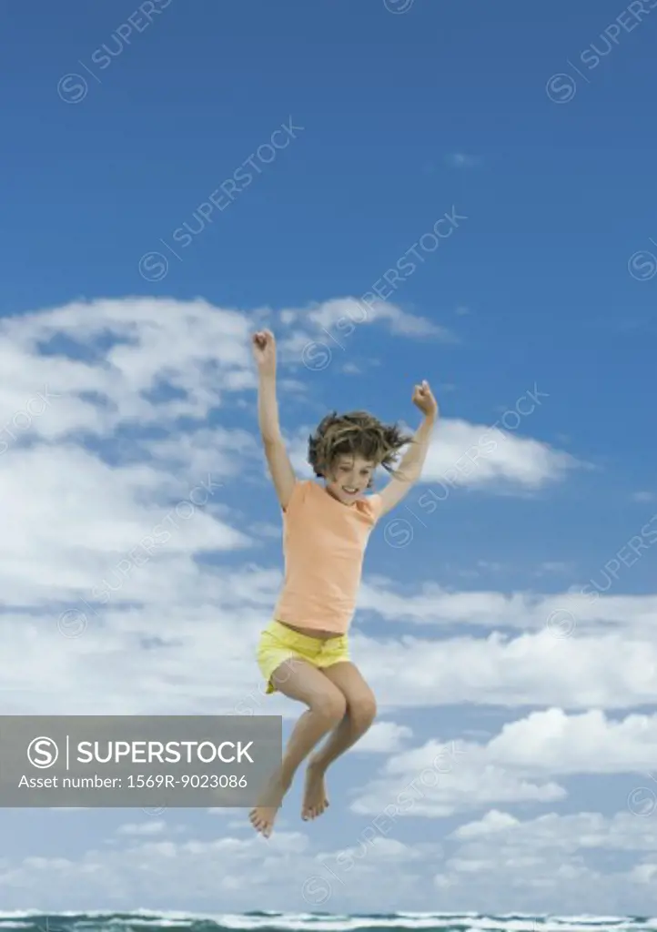 Girl jumping, sky in background