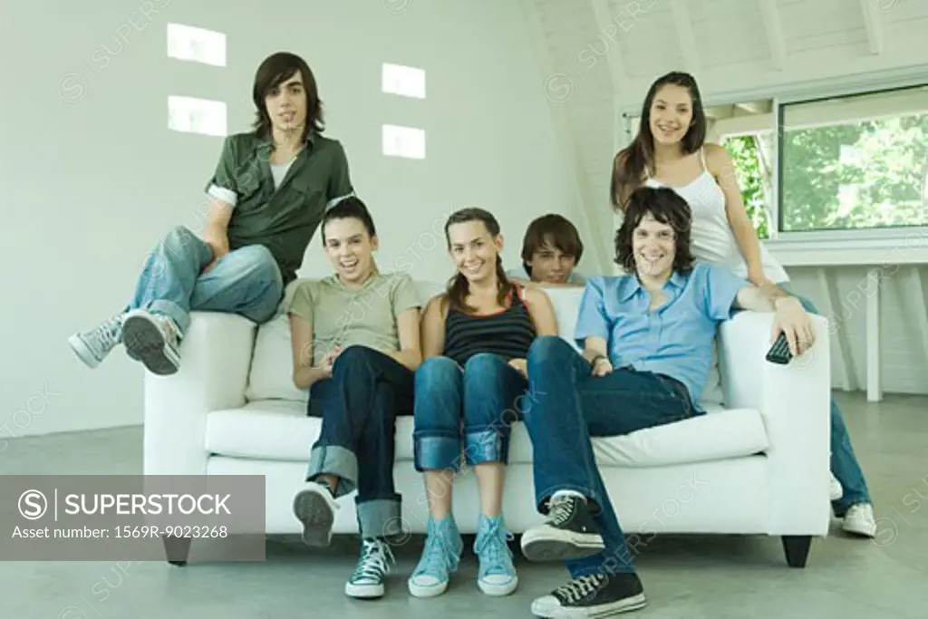 Group of young friends sitting on sofa