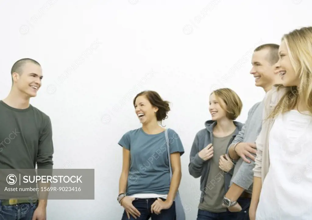 Group of young adults standing, laughing