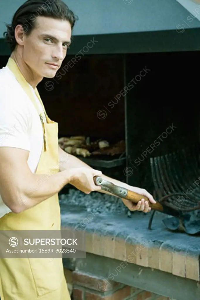 Man cleaning out barbecue