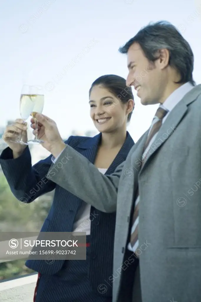 Business partners clinking glasses of champagne