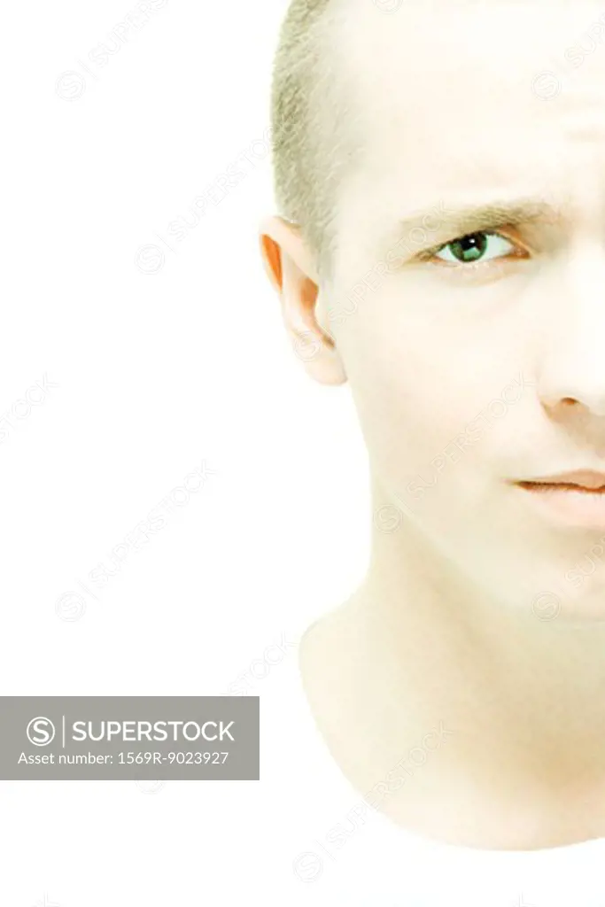 Young man furrowing brow at camera