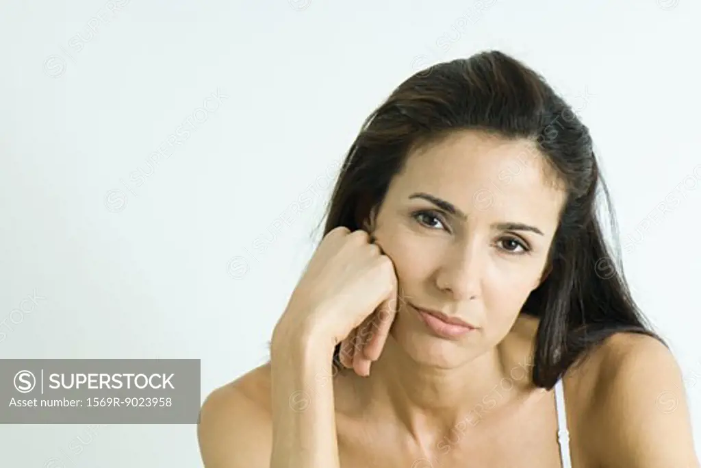 Woman holding head, pouting, portrait