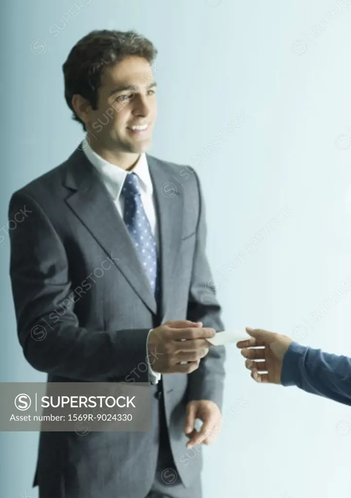 Businessman holding out business card