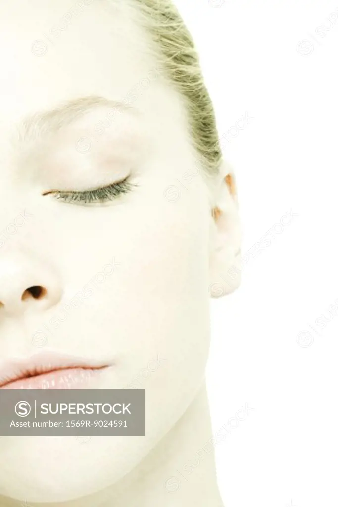 Teenage girl's face, eye closed, extreme close-up