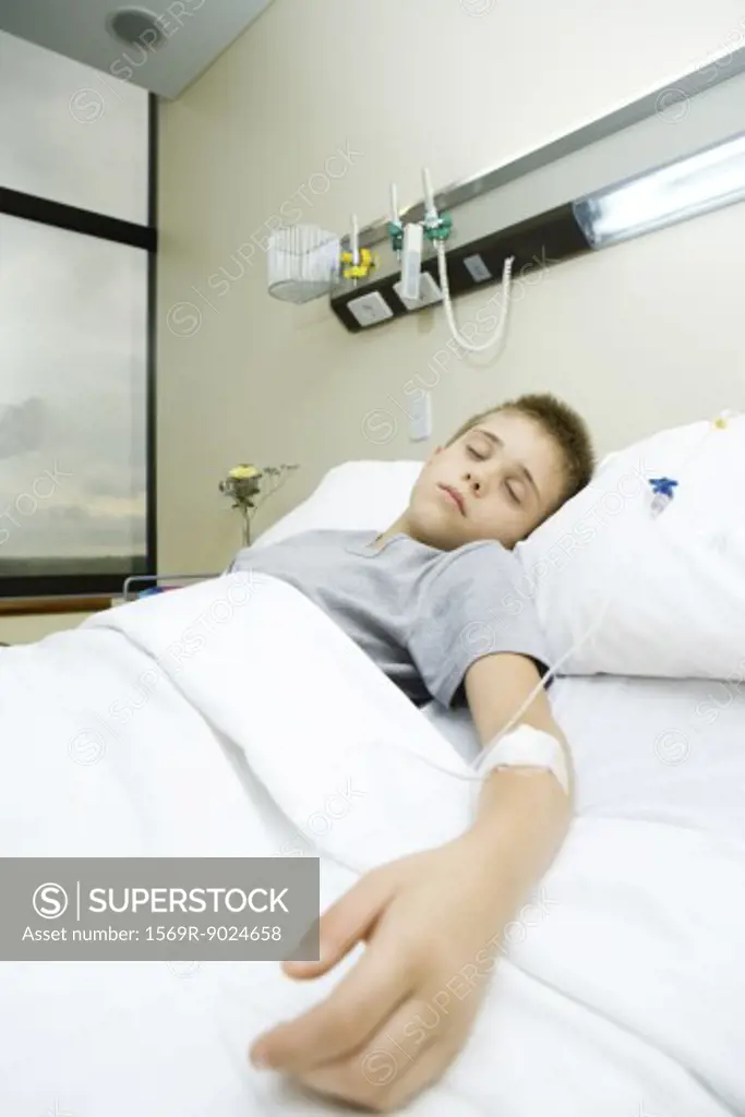 Boy lying in hospital bed