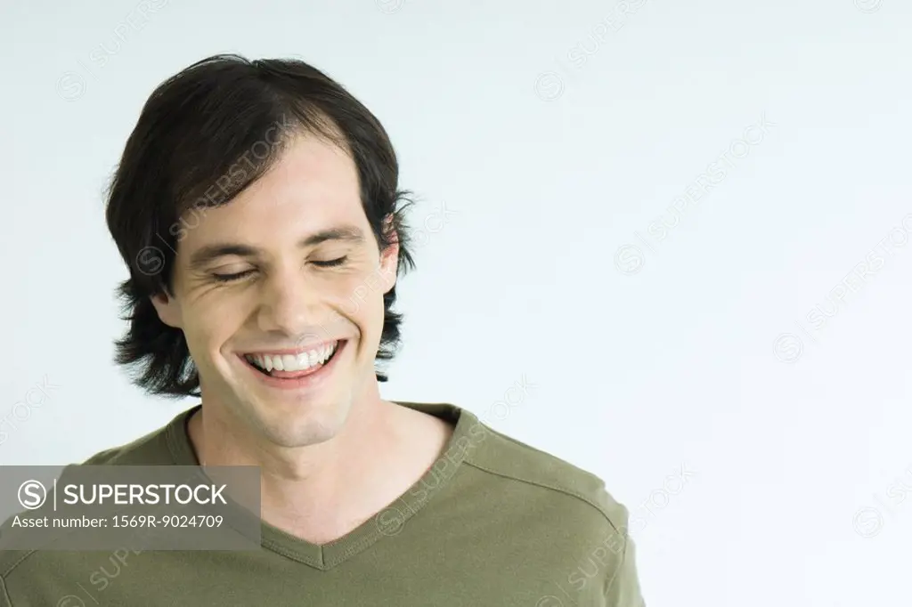 Man smiling, eyes closed, portrait