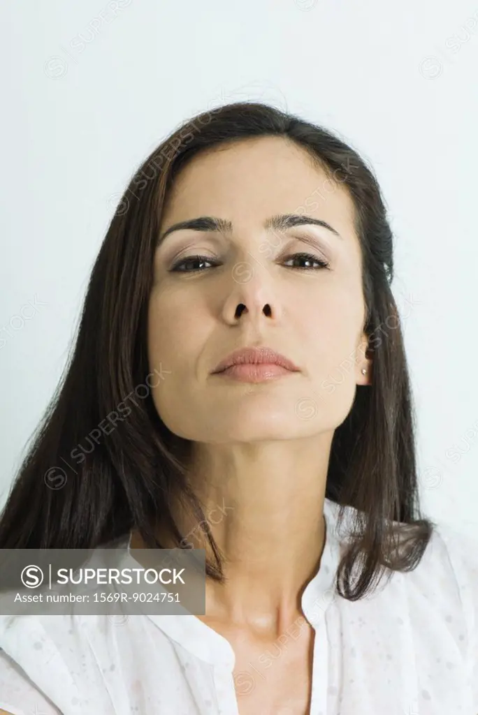 Woman looking down nose at camera, portrait