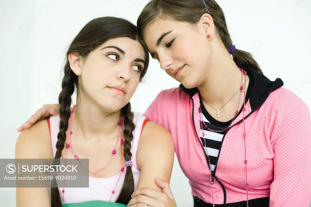 Two young female friends, one comforting the other
