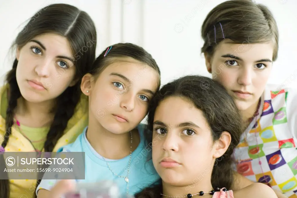 Four young female friends looking glum, portrait
