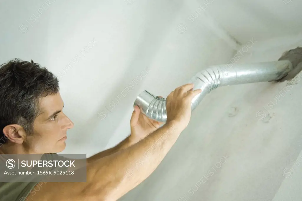 Man installing air duct