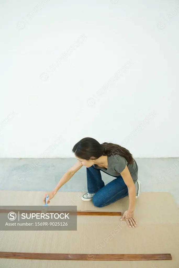 Woman staining slats of wood