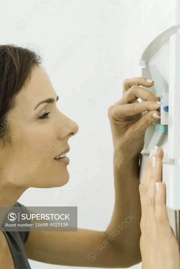 Woman pushing lever in fuse box