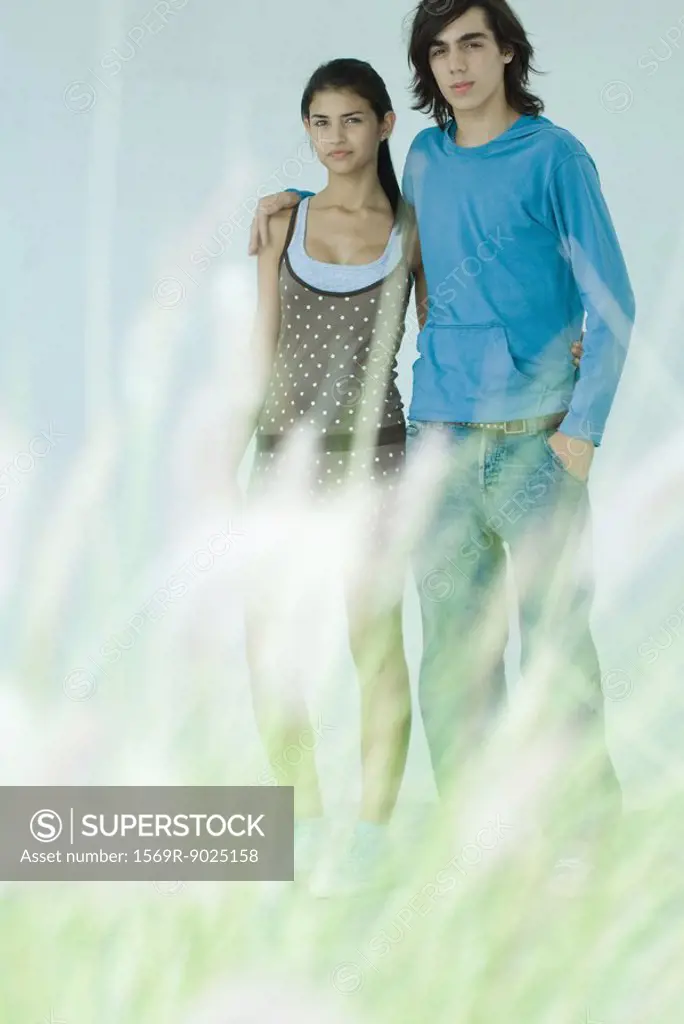 Young couple, focus on background, full length