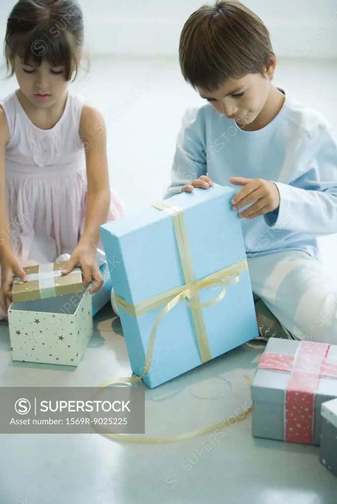 Boy and girl opening presents